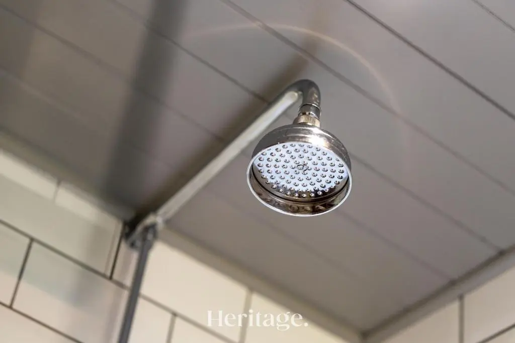 a shower head hanging from the ceiling of a bathroom at The Byre, Countryside Home in Tough