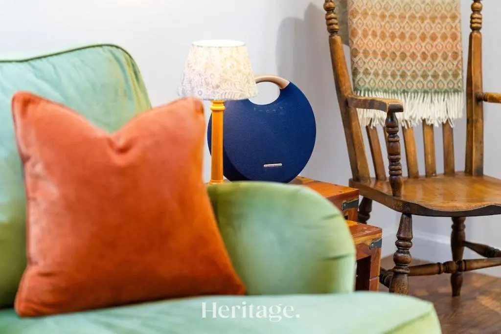 a lamp sitting next to a chair and a pillow at The Byre, Countryside Home in Tough
