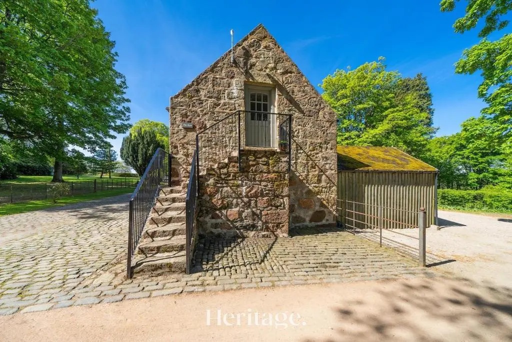 an old stone church with a fence around it at The Byre, Countryside Home in Tough