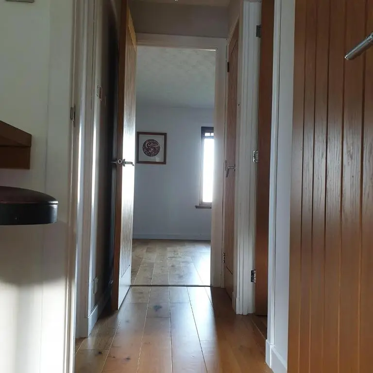 a hallway with an open door to a room at 1 Bed Apartment Inverness with City Views in Inverness