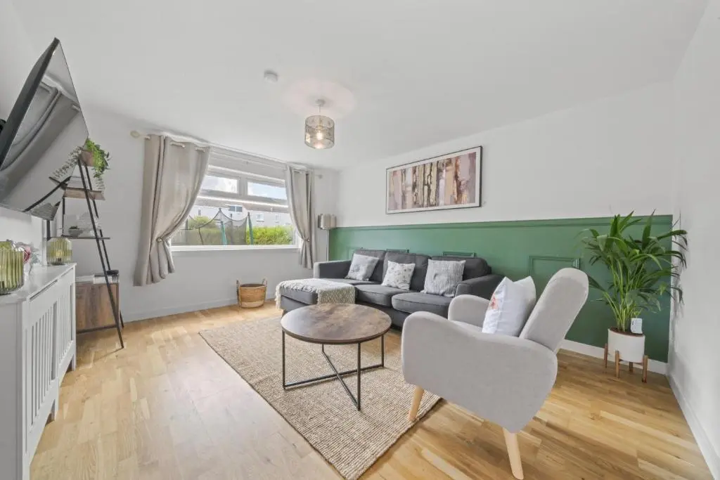 a living room with a couch and a table at Heather 3 Bedroom House - Inverness in Inverness