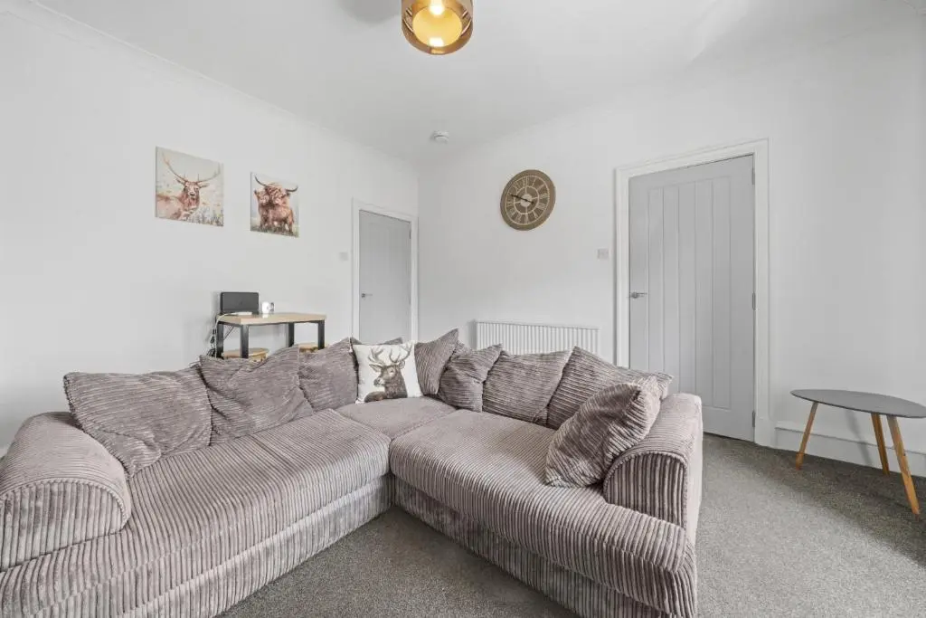 a living room with a couch and a table at Crown 3 Bedroom Apartment - Inverness in Inverness
