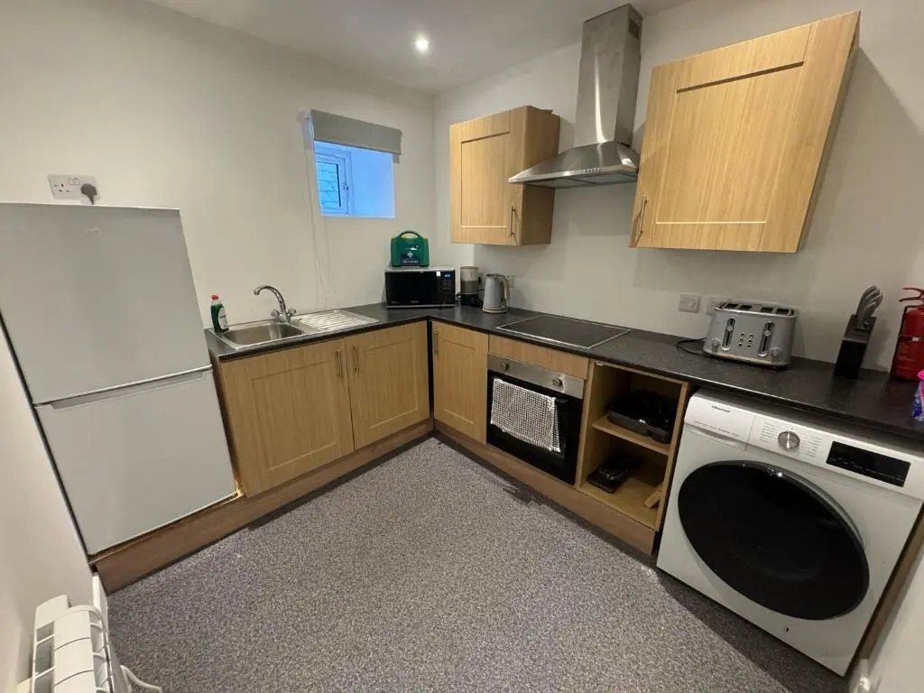 a kitchen with a white refrigerator and a dishwasher at Taigh Mor in Elgin