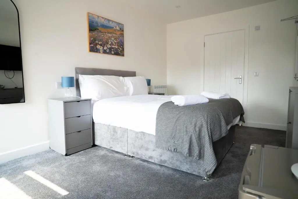 a bedroom with a large bed and a television at Taigh Mor in Elgin