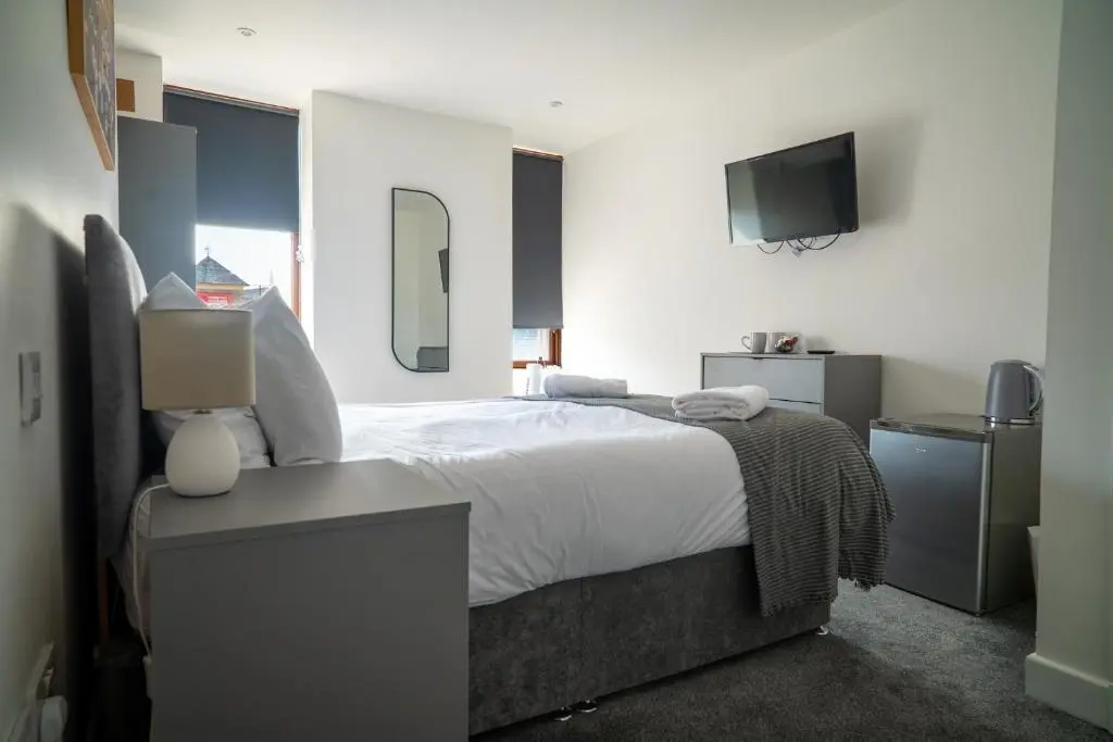 a bedroom with a large bed and a television at Taigh Mor in Elgin