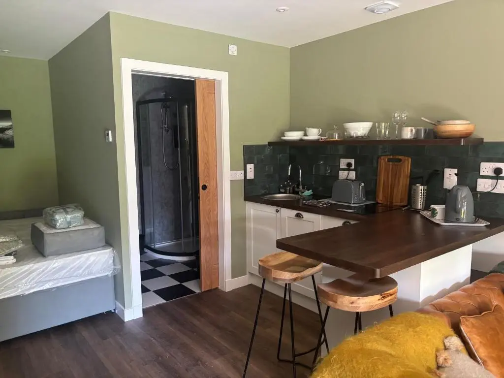 a kitchen with a table and a counter top at The Studio at Rannagowan in Ballater