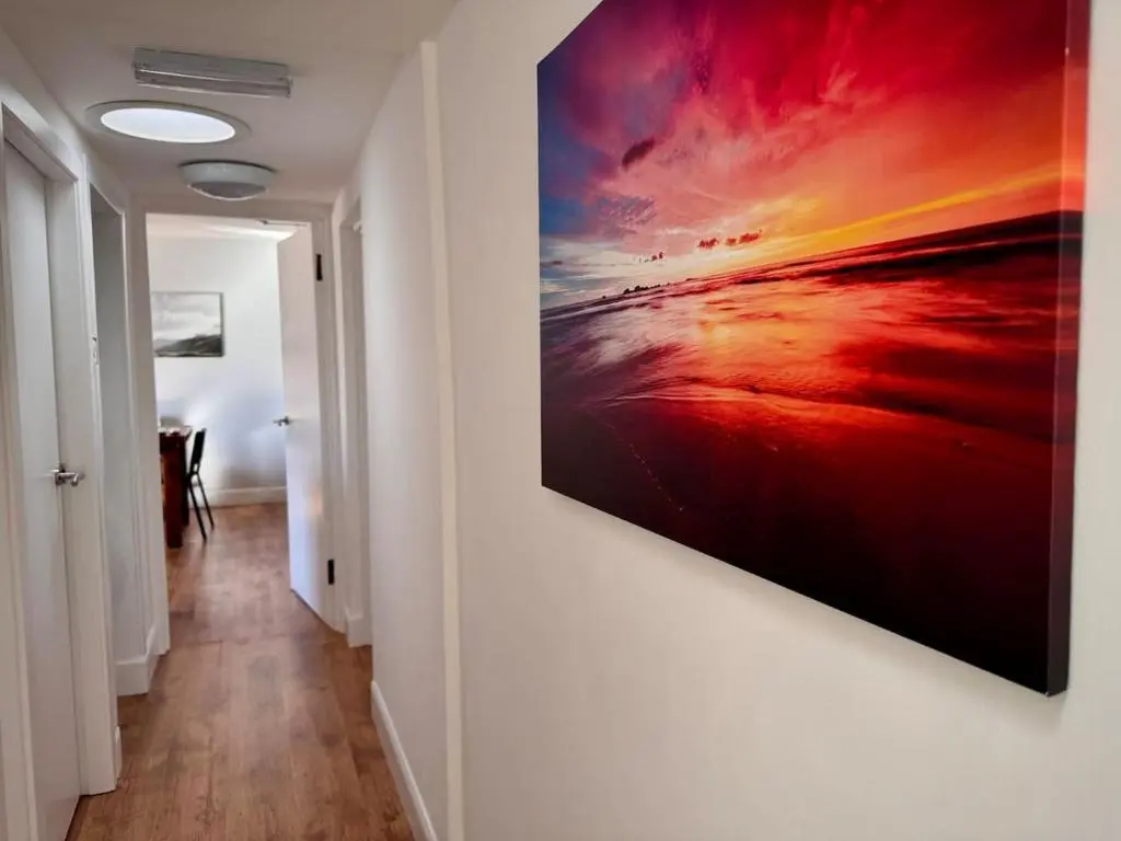 a painting hanging on a wall in a hallway at Coorie House in Elgin in Elgin