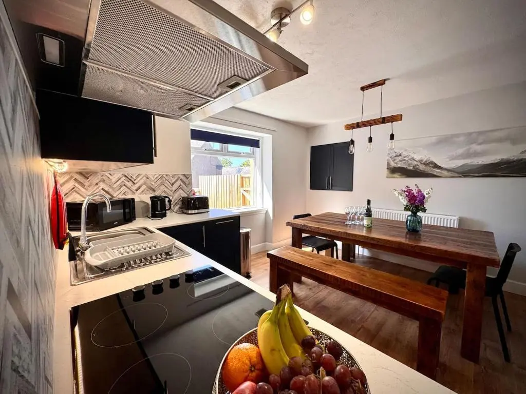 a kitchen with a bowl of fruit on a counter at Coorie House in Elgin in Elgin