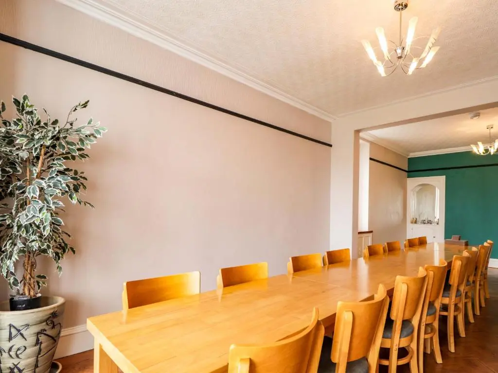 a large conference room with a long table and chairs at Crannoch Self Catering in Buckie