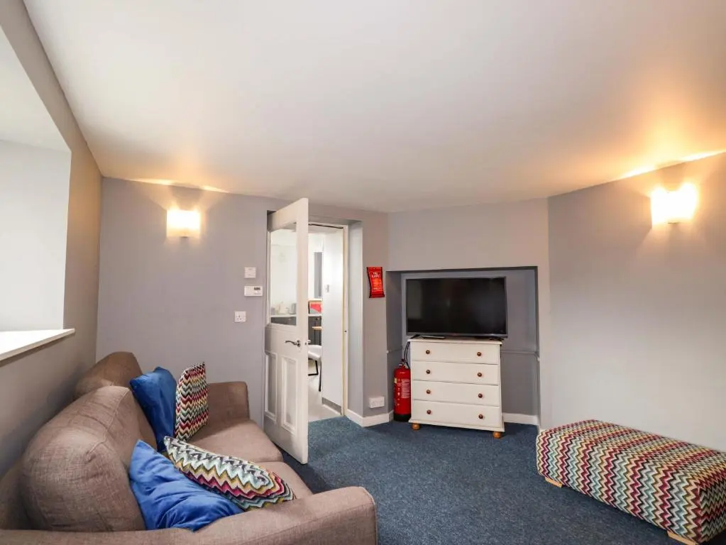 a living room with a couch and a tv at Crannoch Self Catering in Buckie