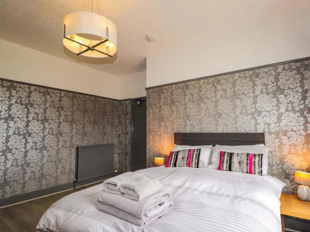 a bedroom with a bed with towels on it at Crannoch Self Catering in Buckie