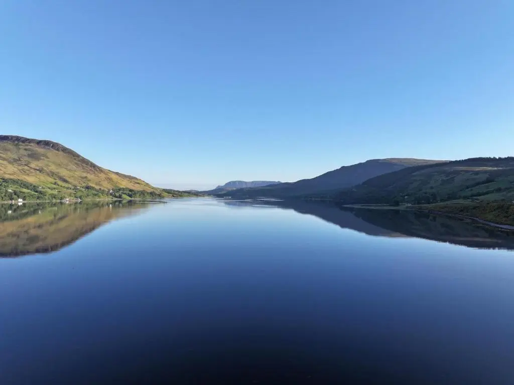 a view of a lake with hills in the background at Lochend Pods - Deas Pod in Inverlael