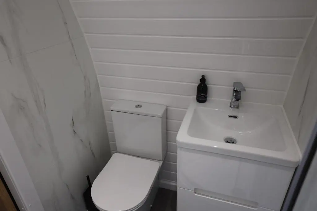 a small bathroom with a toilet and a sink at Lochend Pods - Cl\u00ec Pod in Inverlael