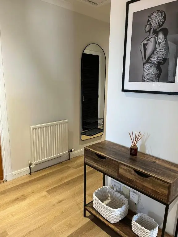 a living room with a table and a mirror at Covesea Horizon in Elgin