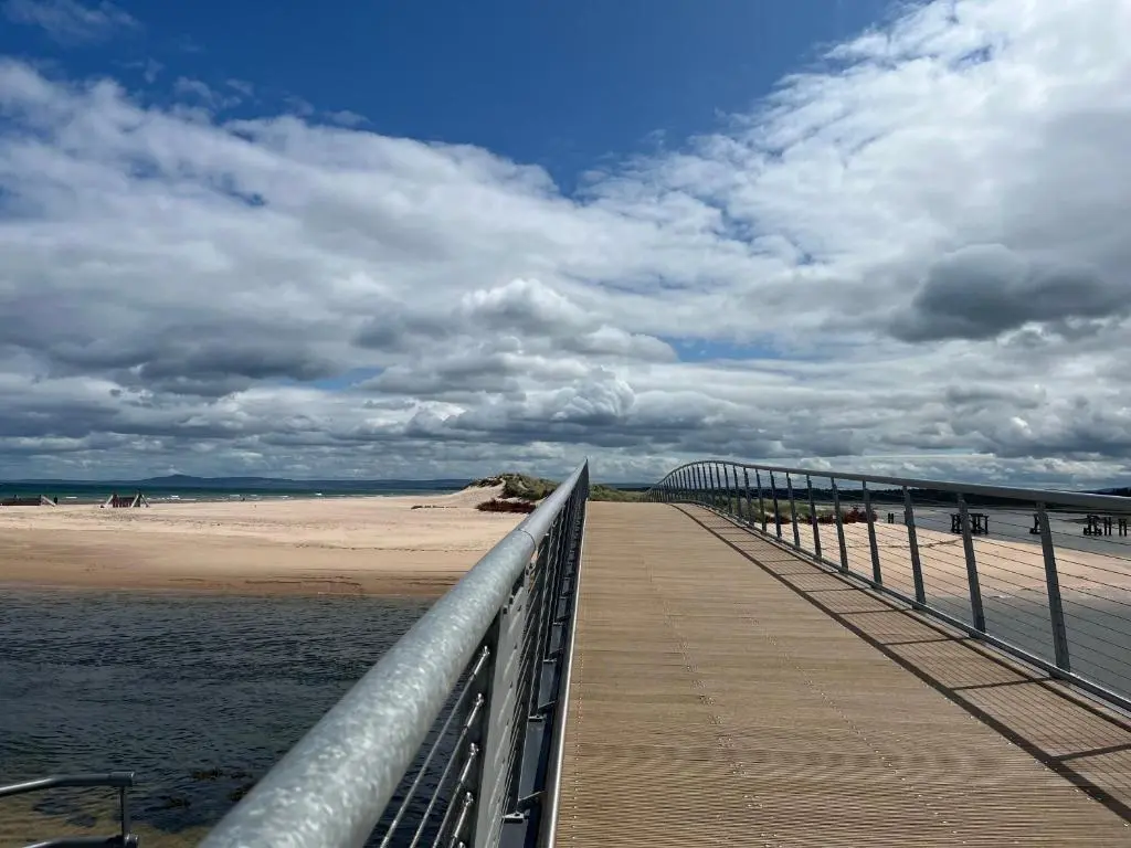 a boardwalk leading to a beach with a cloudy sky at Covesea Horizon in Elgin
