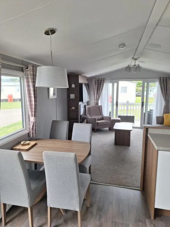 a dining room with a table and chairs at Northern Lights in Lossiemouth