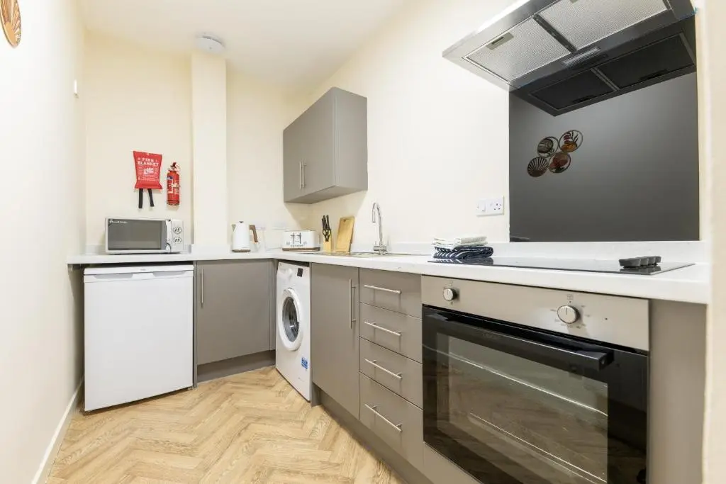 a kitchen with a sink and a dishwasher at Alba Apartment in Inverness