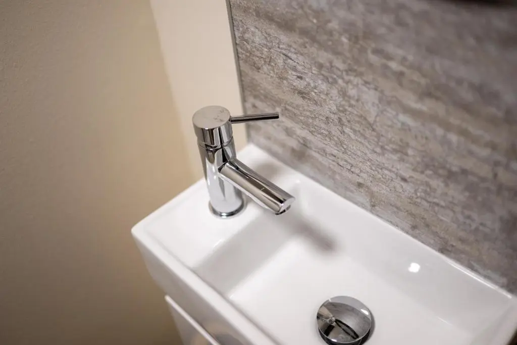 a bathroom sink with a faucet on top of it at Alba Apartment in Inverness