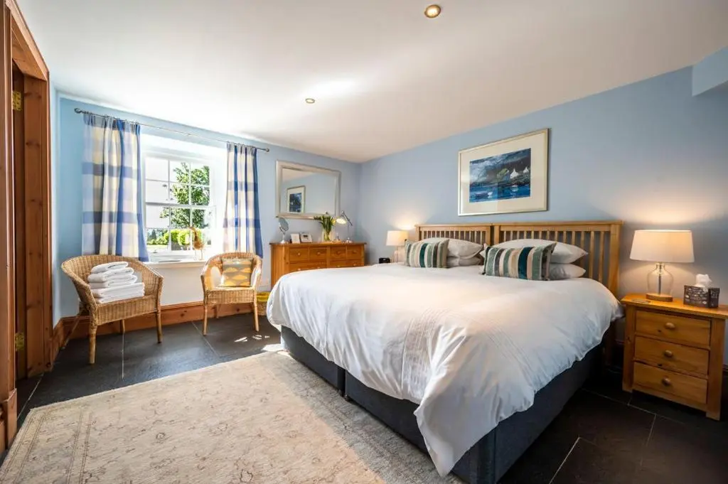 a bedroom with a large bed and a window at Ross-shire Hall in Evanton