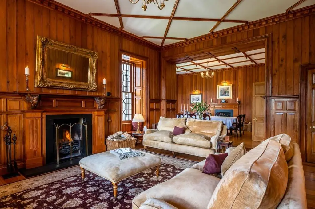 a living room filled with furniture and a fireplace at Ross-shire Hall in Evanton