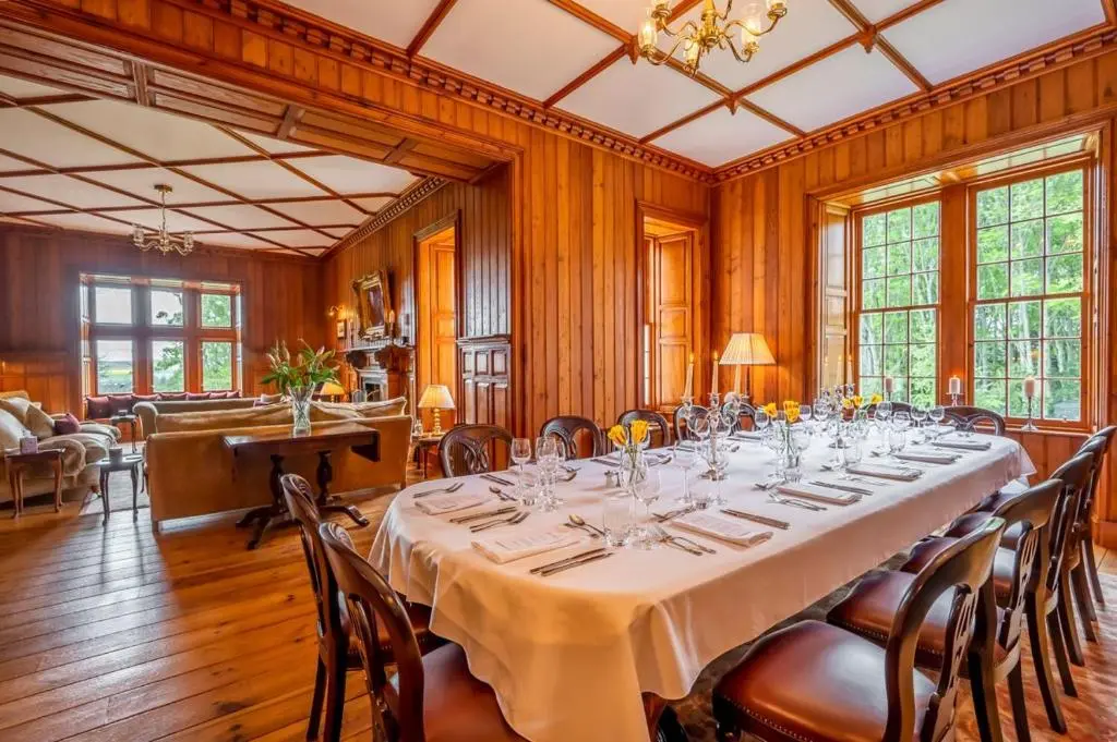 a large dining room with a long table and chairs at Ross-shire Hall in Evanton