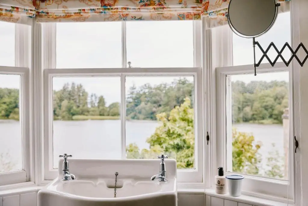 a bathroom with a sink and a large window at The Secret Loch in Lhanbryd