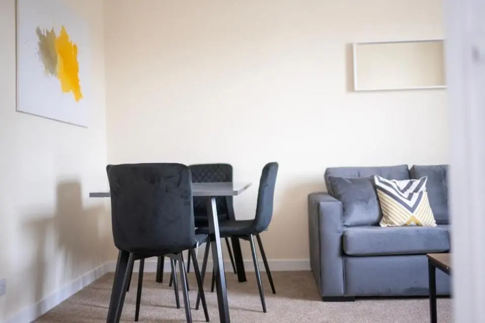 a living room with a table and chairs and a couch at 1 BDR Apt By Caledonia Luxe Stays Short Lets & Serviced Accommodation Inverness in Inverness