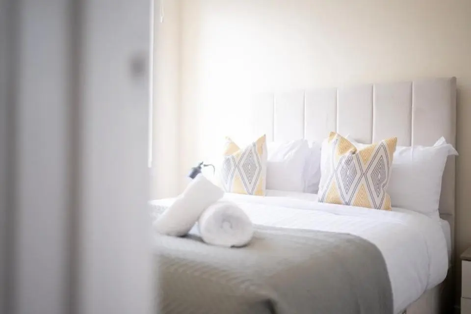a white bed with a white headboard and pillows at 1 BDR Apt By Caledonia Luxe Stays Short Lets & Serviced Accommodation Inverness in Inverness