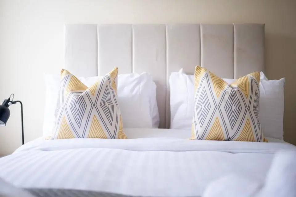a bed with white sheets and pillows on it at 1 BDR Apt By Caledonia Luxe Stays Short Lets & Serviced Accommodation Inverness in Inverness