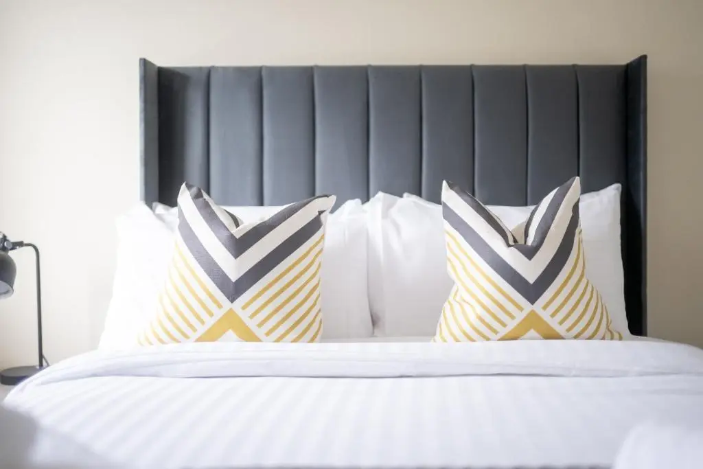 a bedroom with a bed with two pillows on it at 1 BDR Flat At Caledonia Luxe Stays Short Lets & Serviced Accommodation Inverness in Inverness