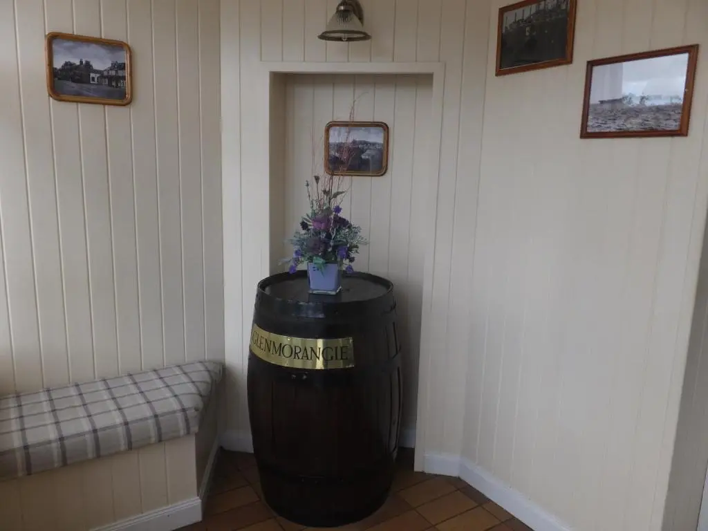 a room with a barrel with a plant on it at Novar Arms Hotel in Evanton