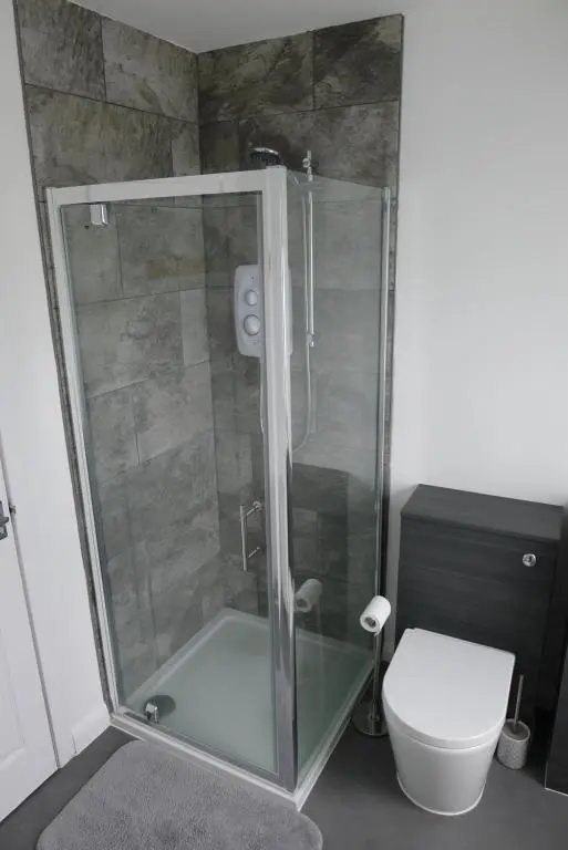 a shower stall in a bathroom with a toilet at Hanover st partment in Fraserburgh