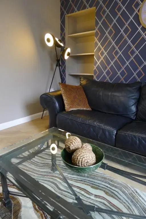 a living room with a couch and a glass table at Hanover st partment in Fraserburgh