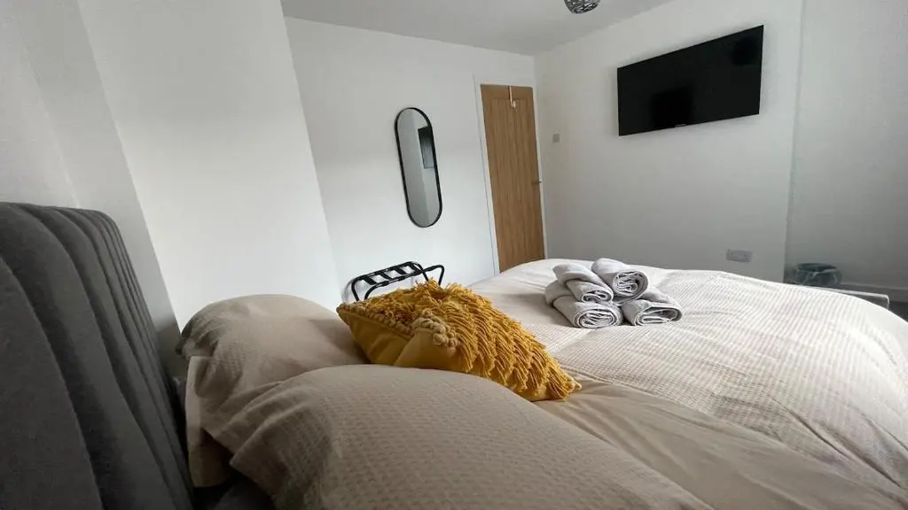 a bedroom with a bed with stuffed animals on it at The Den - by Caithness Luxury Apartments NC500 - 2 Bedroom holiday home - Sleeps Work teams upto 2 & holiday makers upto 4 in Wick