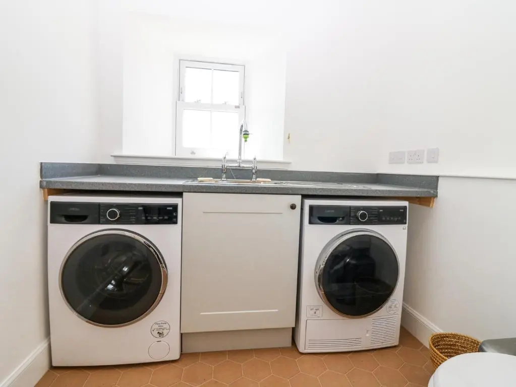 a kitchen with two washing machines and a sink at The Crannach in Blairgowrie