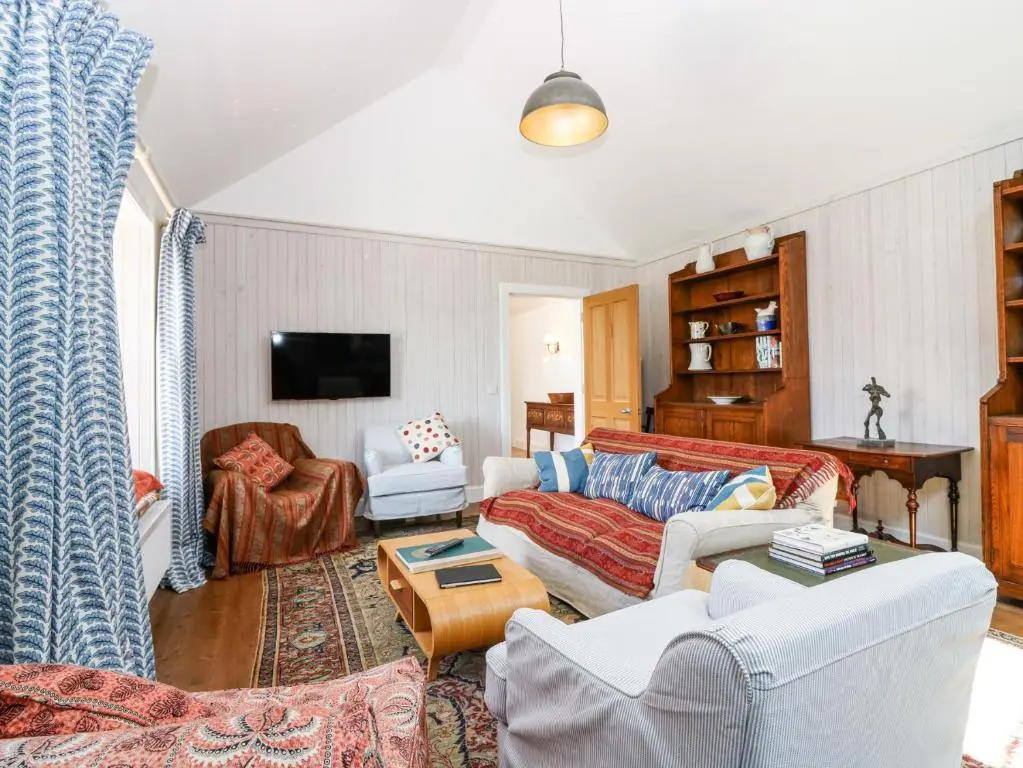 a living room with a couch and a table at The Crannach in Blairgowrie