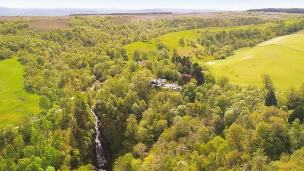an aerial view of a house in a forest at Dhivach Lodge in Drumnadrochit