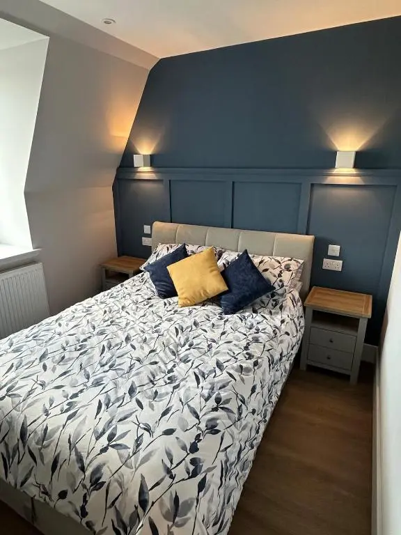 a bedroom with a bed with two pillows on it at Highland Home on the Hill in Inverness