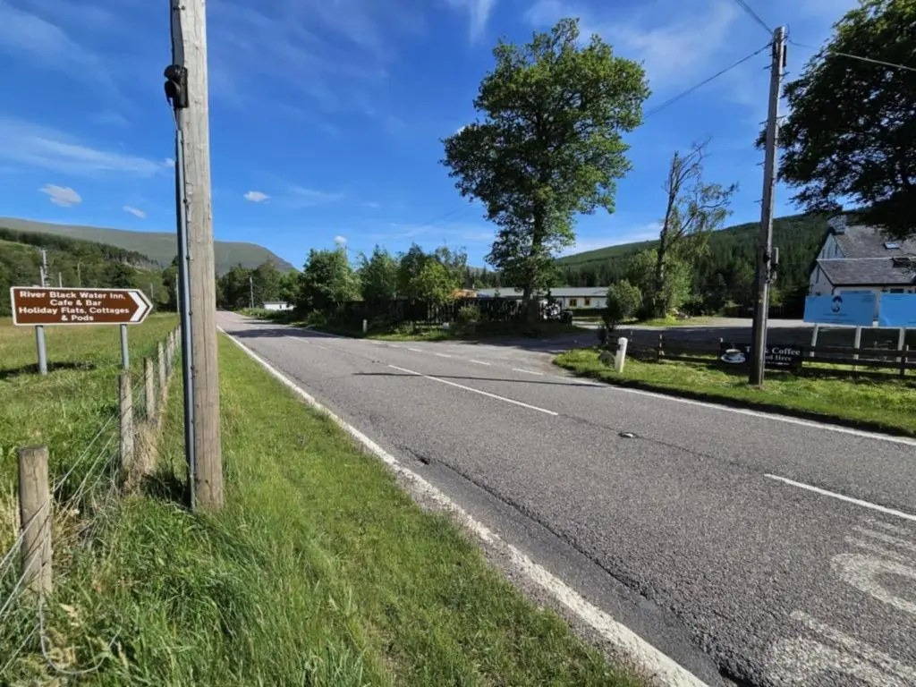 an empty road with a sign on the side at Tonita in Garve