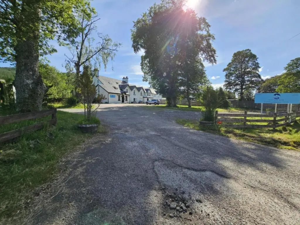 an empty road in front of a house at Tonita in Garve