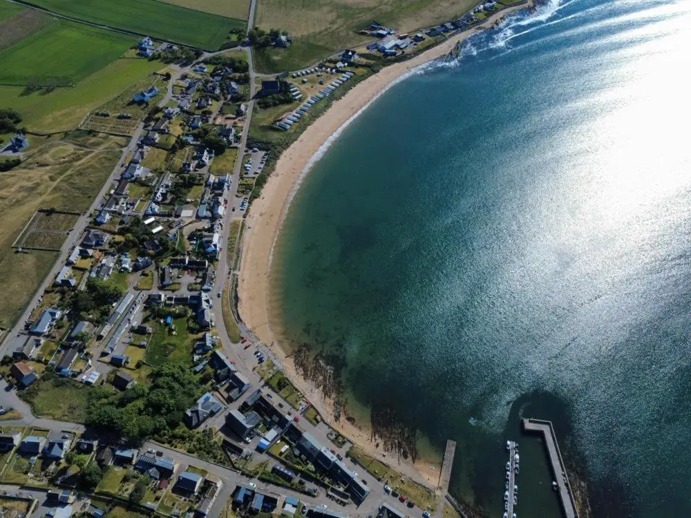 an aerial view of a beach and the ocean at The Castle Hotel NR TAIN in Portmahomack