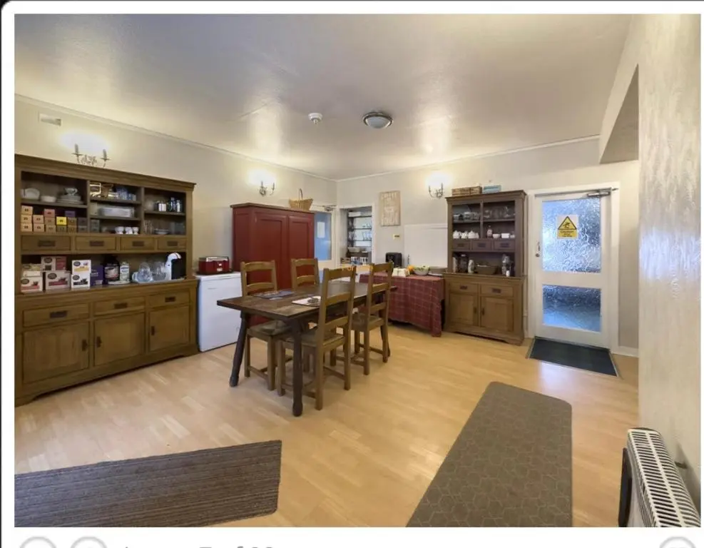 a kitchen and dining room with a table and chairs at The Castle Hotel NR TAIN in Portmahomack