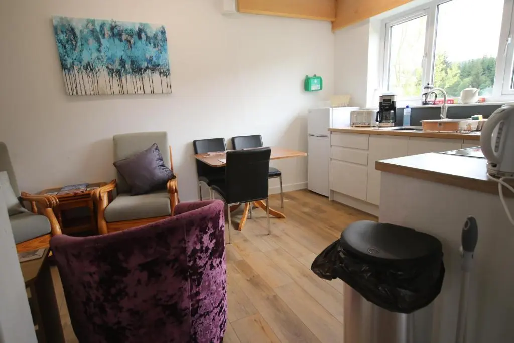 a kitchen with chairs and a table and a counter at Owl View in Garve
