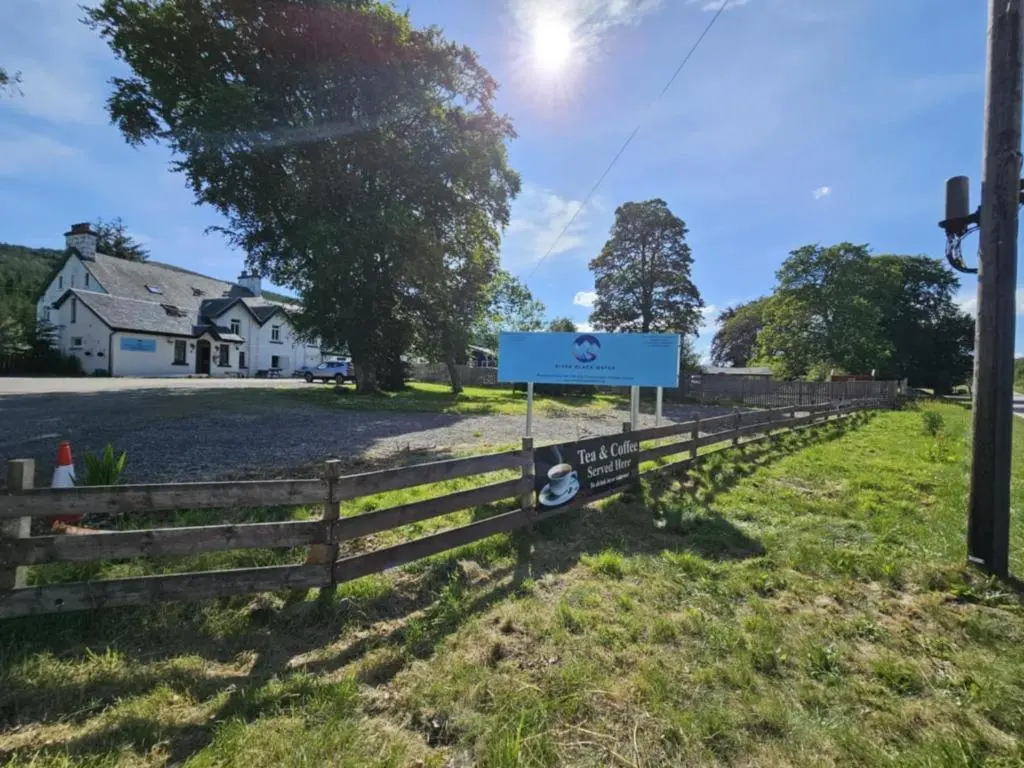 a fence with a sign in front of a house at Owl View in Garve