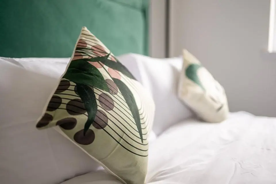 two pillows are sitting on a white couch at 1 BDR Apartment At Caledonia Luxe Stays Short Lets & Serviced Accommodation Inverness in Inverness