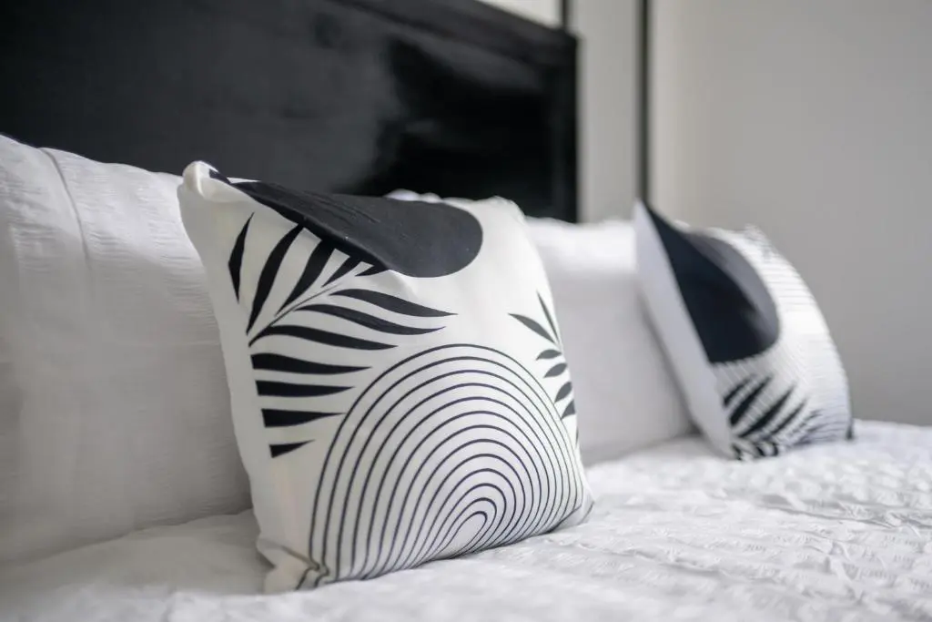 two black and white pillows on a bed at Dram Apartment in Inverness