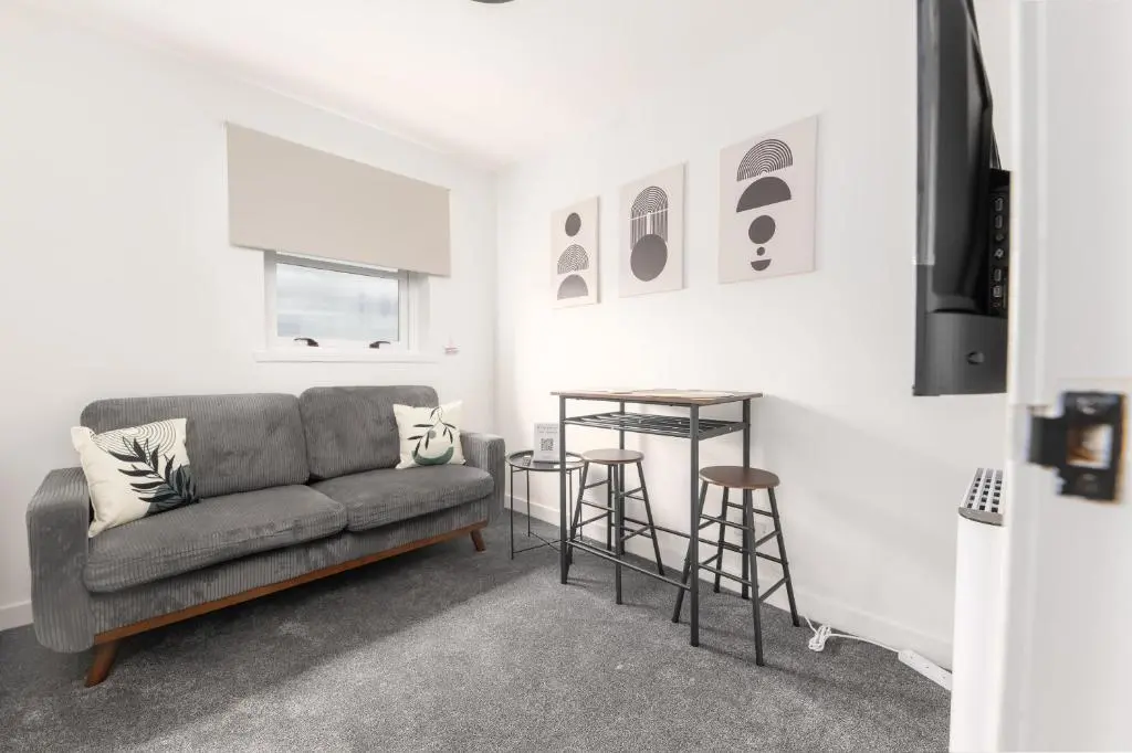 a living room with a couch and a table at Dram Apartment in Inverness