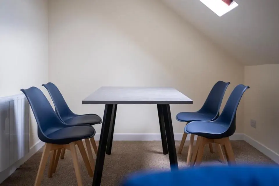 four blue chairs around a table in a room at 2 BDR Apt At Caledonia Luxe Stays Short Lets & Serviced Accommodation Inverness in Inverness
