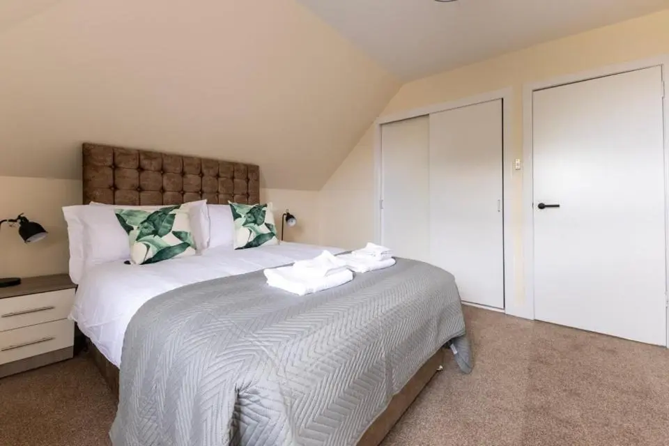 a bedroom with a large white bed and a closet at 2 BDR Apt At Caledonia Luxe Stays Short Lets & Serviced Accommodation Inverness in Inverness