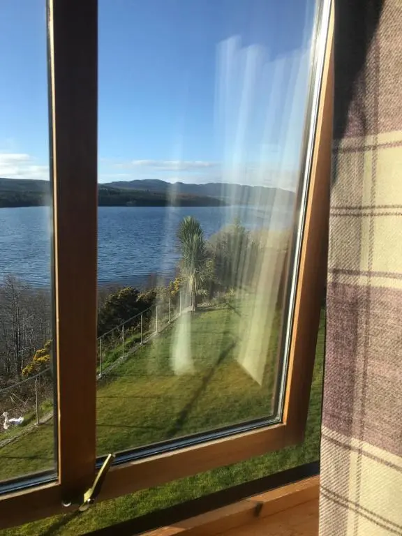 a view of a lake from a window at Kimcraigan B&B in Brackla